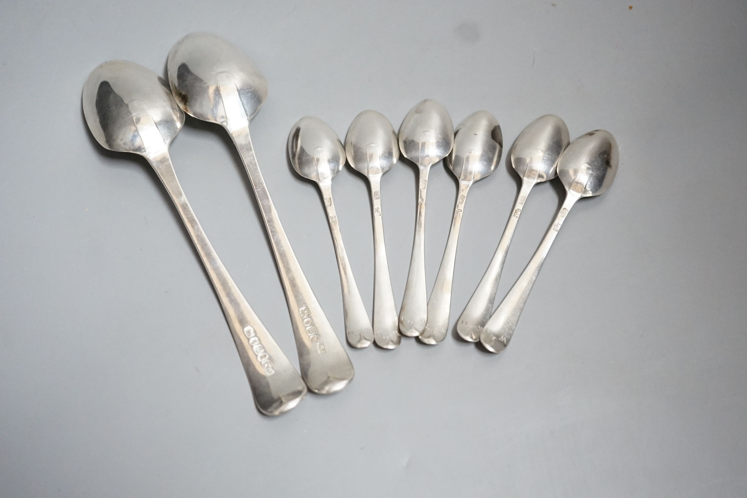 A set of silver George III bright cut engraved silver Old English pattern teaspoons, by Hester Bateman, no date letter and a pair of George III silver bright cut engraved Old English tablespoons, London, 1787